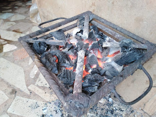 Akor Happiness, burning local charcoal stove (Abacha stove) to prepare meal for her children. Photocredit: Samuel Ajala